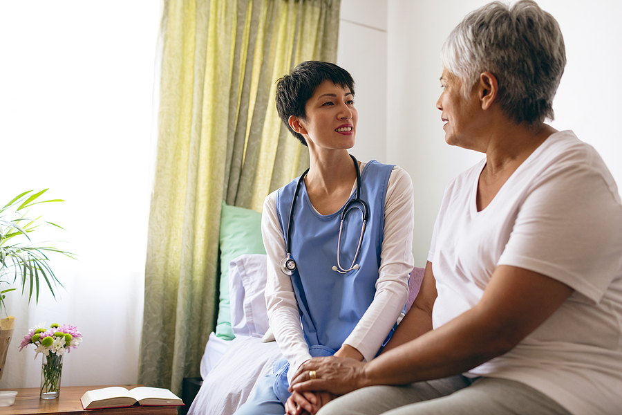Low angle view of beautiful Asian female doctor interacting with