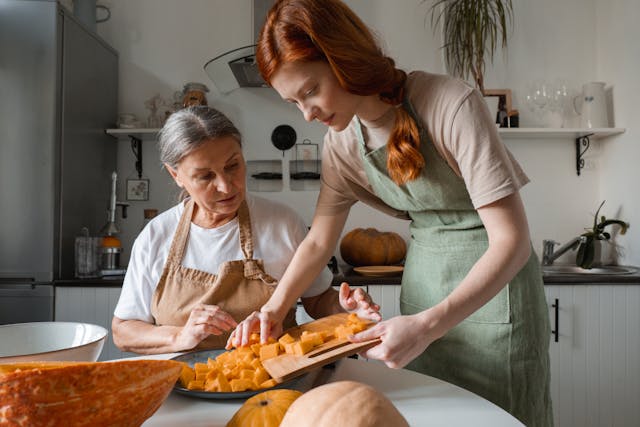 Caregiver assists senior with meal prep, reflecting personalized, high-quality home care support