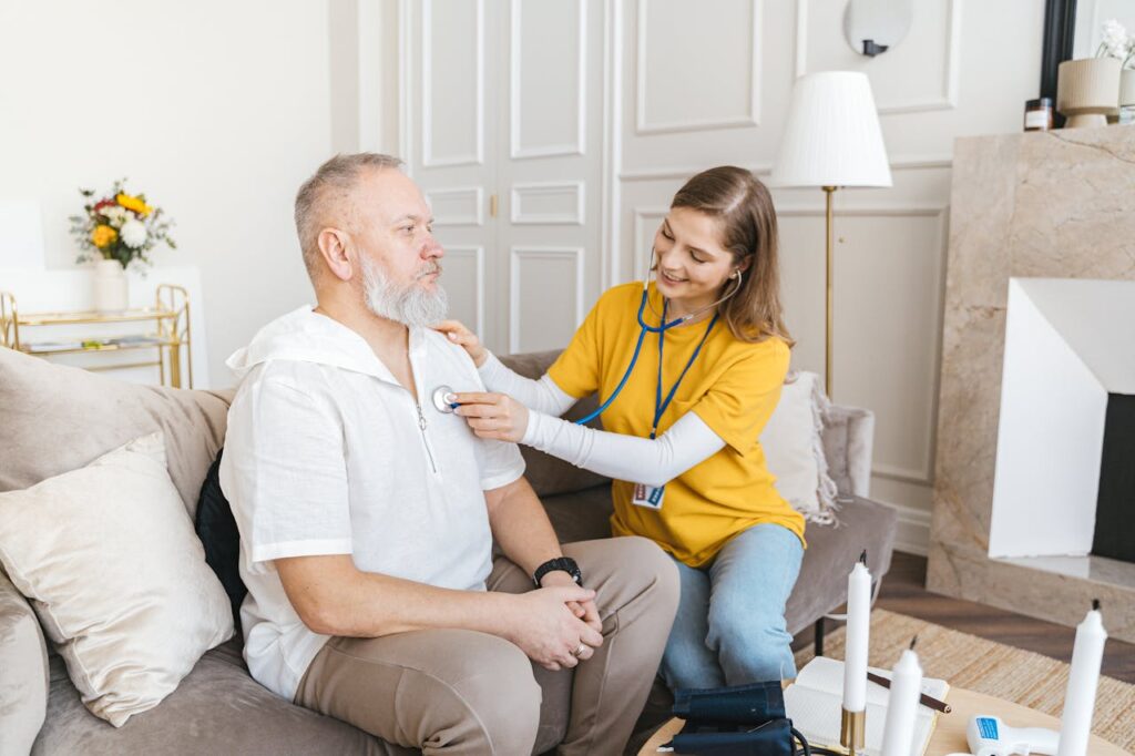 nurse providing examination for man at home