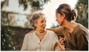 3251ec0ab90a77b1c4bcf1b971c2f53b8813b044 Senior woman and caregiver sharing a warm moment, compassionate in-home care support
